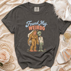 T-shirt with Bigfoot bride and alien groom graphic and "Found My Weirdo" text.