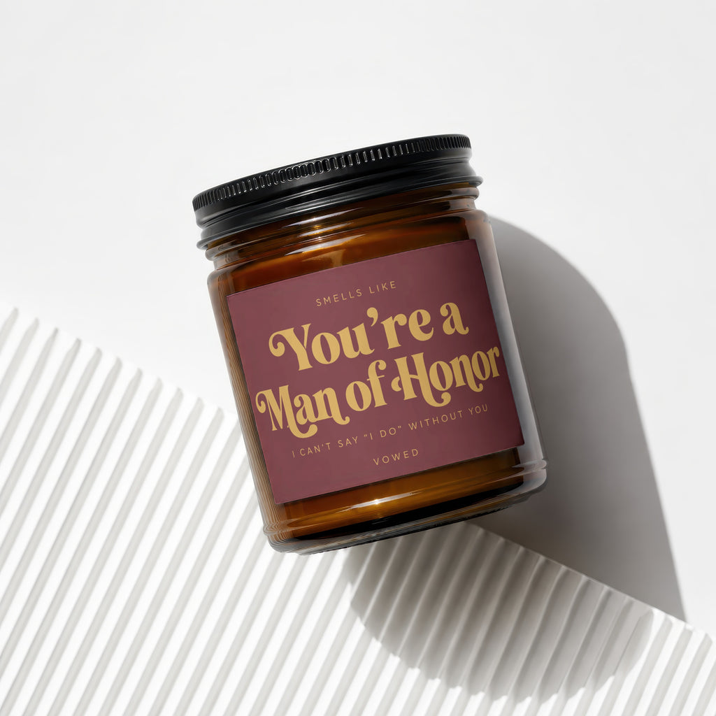 Amber candle with a burgundy label reading "You're a Man of Honor, I Can't Say 'I Do' Without You."