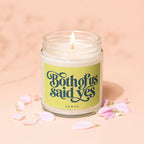 Glass jar candle with "Both of us said yes" text and pink petals.