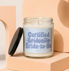 Candle with "Certified Bridezilla Bride-to-Be" text on label and black lid off.