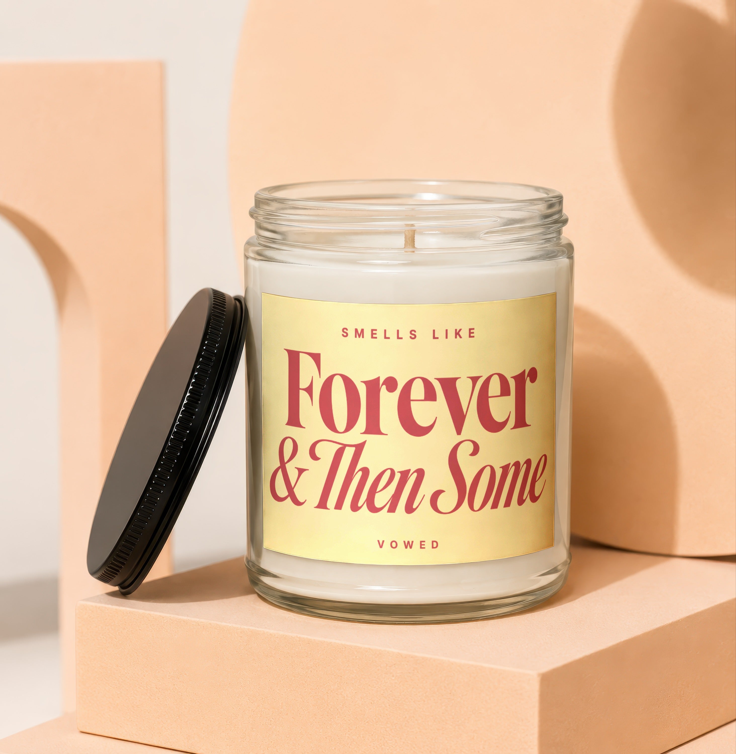 Candle with "Smells Like Forever & Then Some" text and "vowed" inscription.