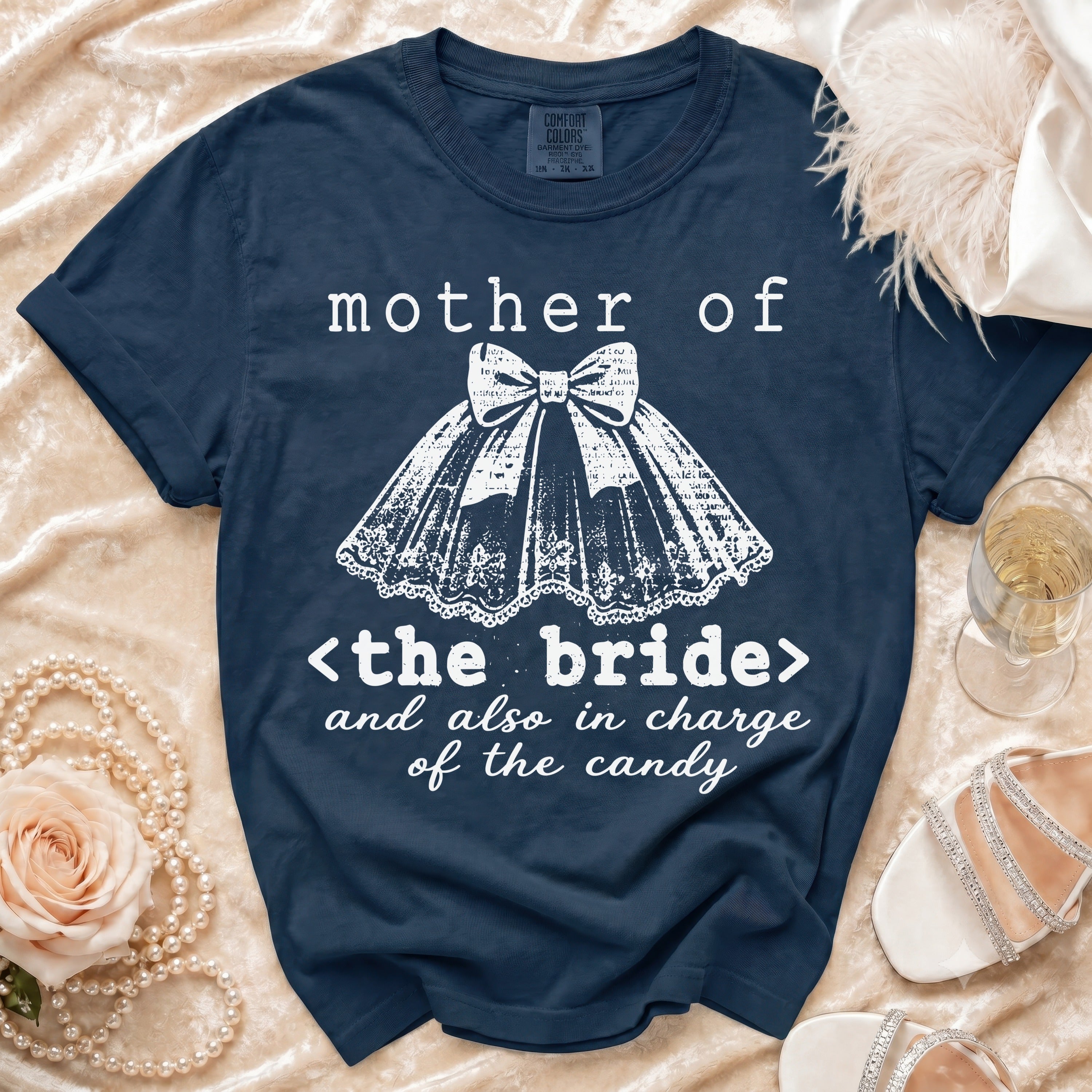 Navy t-shirt with white text and graphics: "mother of <the bride> and also in charge of the candy".