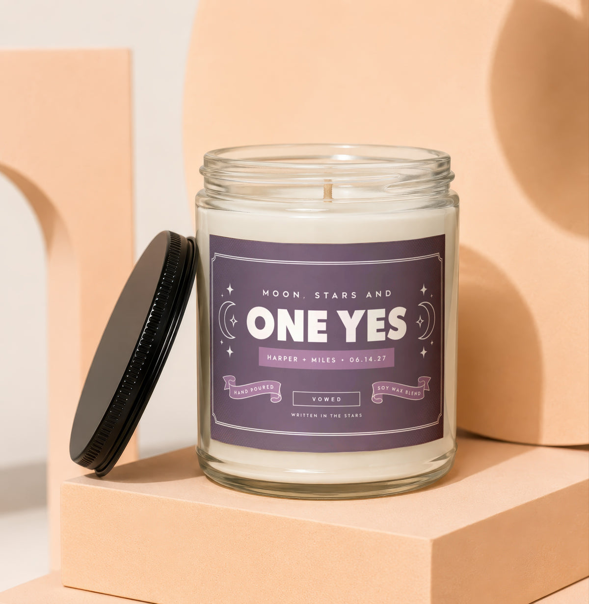 Jar candle with "One Yes" and wedding details on purple label.