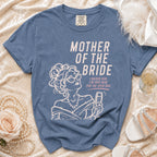Blue t-shirt with "Mother of the Bride" text and graphic of a woman holding champagne.