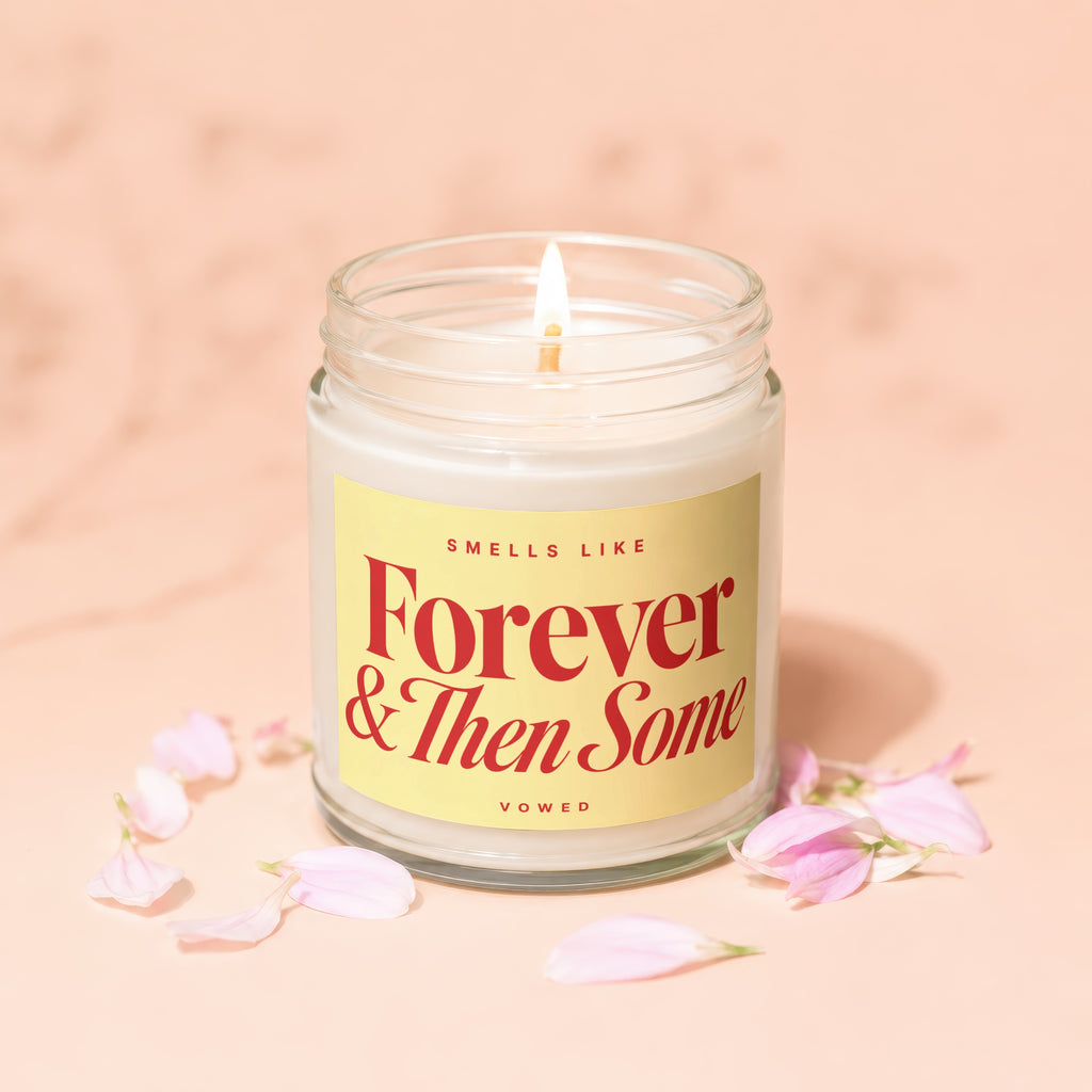 lit candle in jar with label "Smells Like Forever & Then Some Vowed"