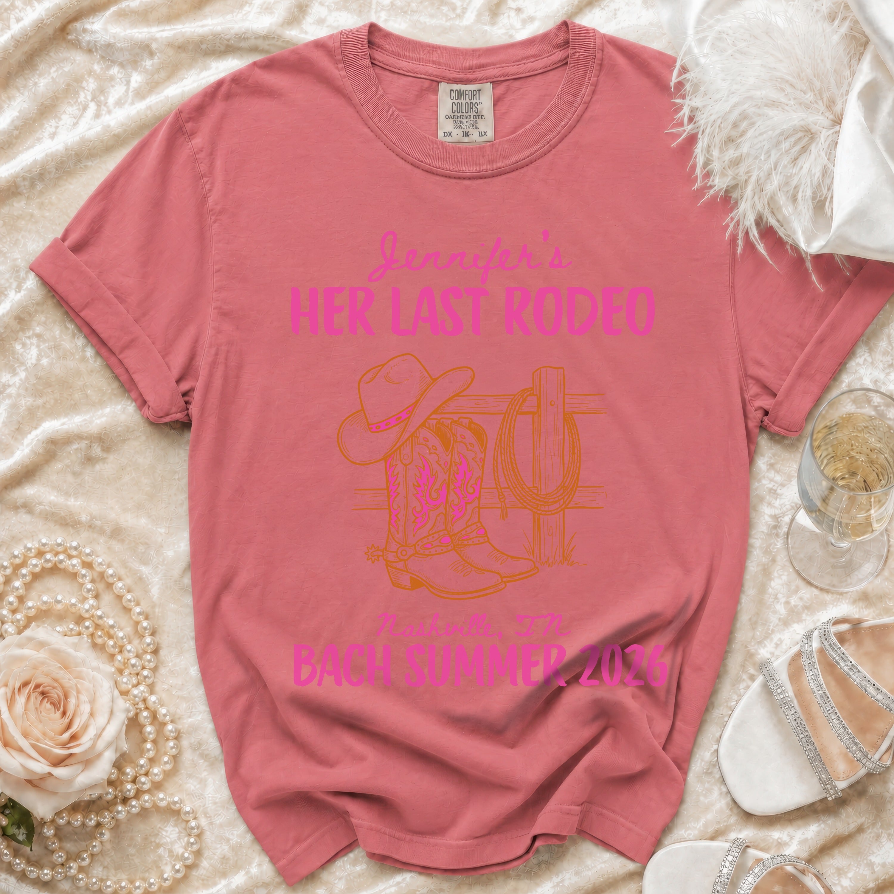 Coral t-shirt with "Jennifer's Her Last Rodeo" and cowboy boots graphic.