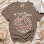 Mother of the Bride graphic t-shirt with wine glass, ring, and floral accents.