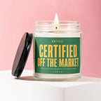 Glass candle with green label saying "Certified Off The Market" on a pink background.
