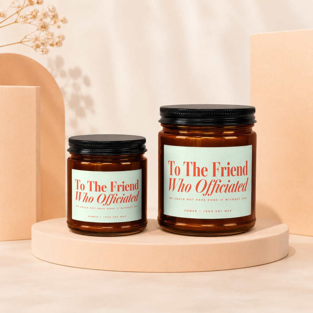 Two amber glass soy wax candles; one smaller than the other.