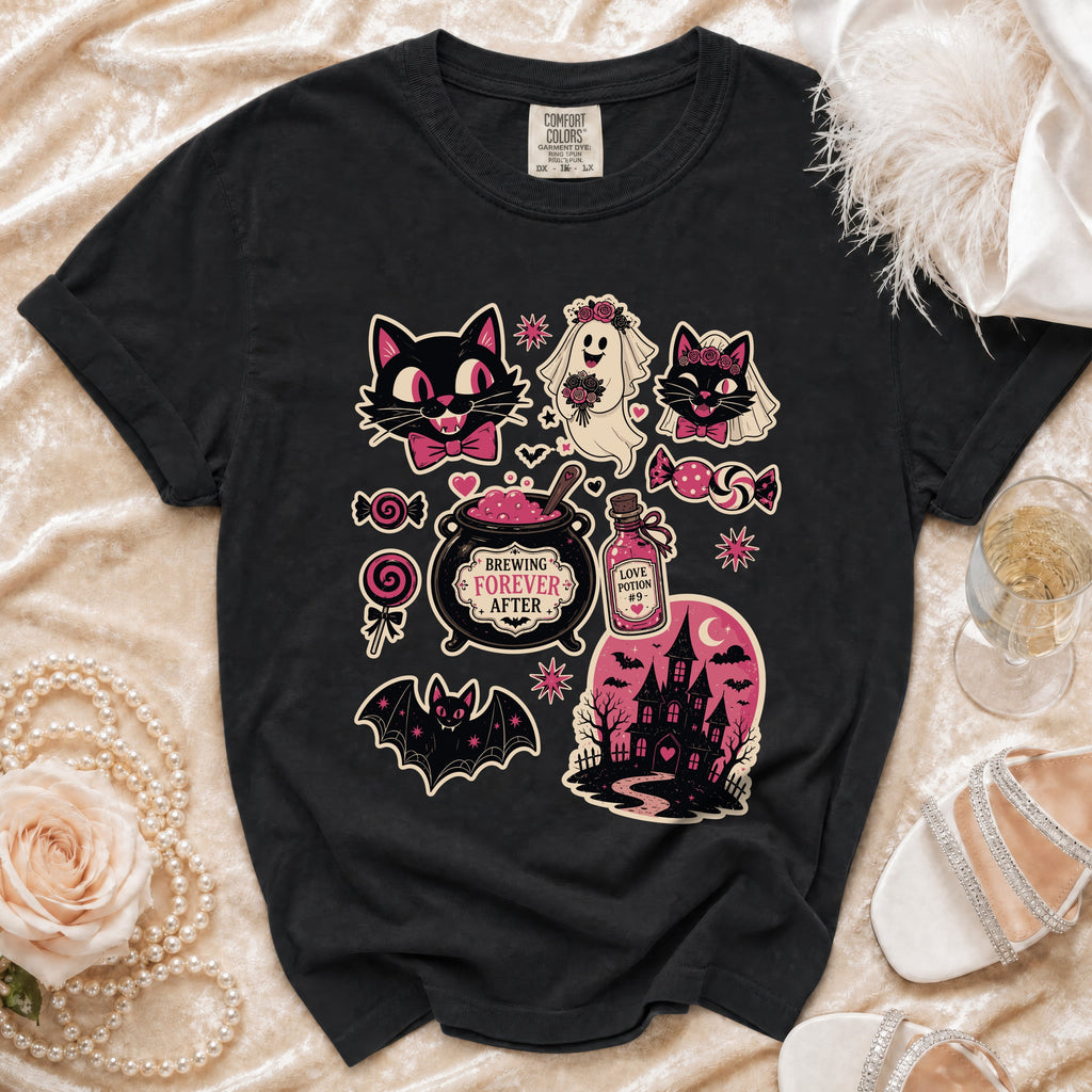 Black t-shirt with Halloween-themed graphic featuring cats, ghost, cauldron, and haunted house.