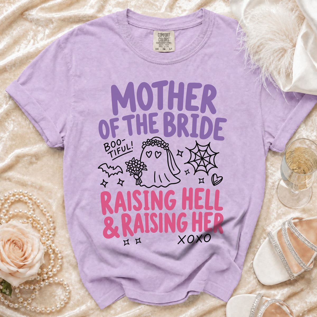 Lavender t-shirt with "Mother of the Bride, Raising Hell & Raising Her" graphic.