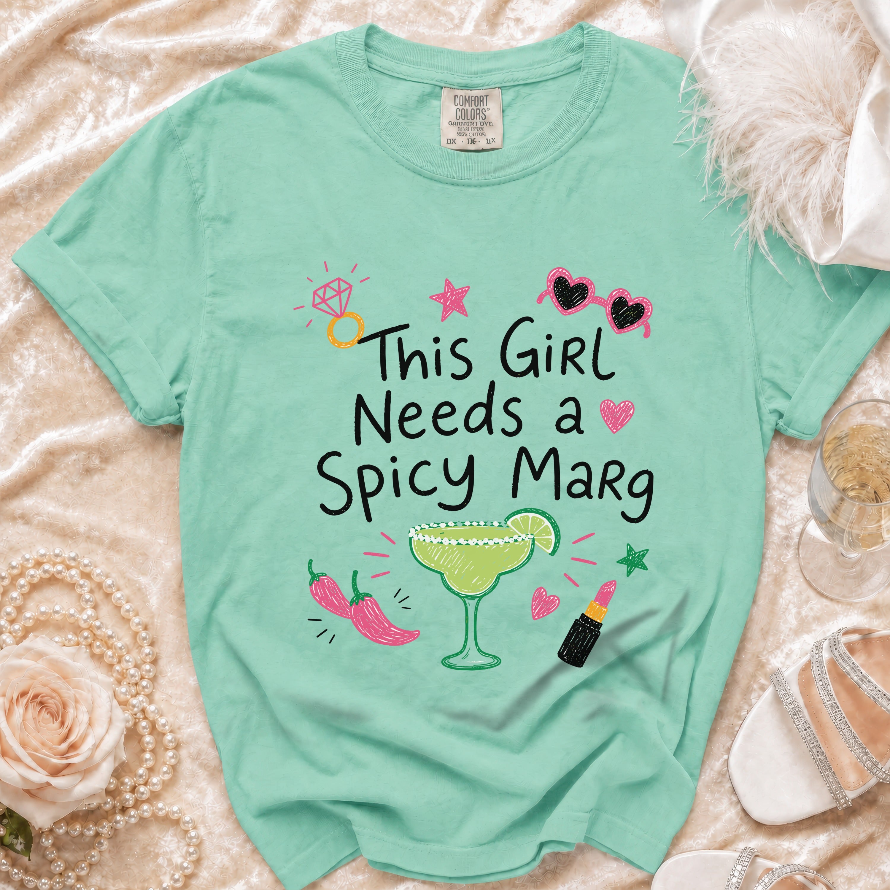 Mint green t-shirt with "This Girl Needs a Spicy Marg" text and drink graphics.