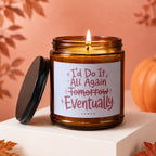 Amber jar candle with lit wick, lid off, reads "I'd do it all again tomorrow... eventually VOWED".