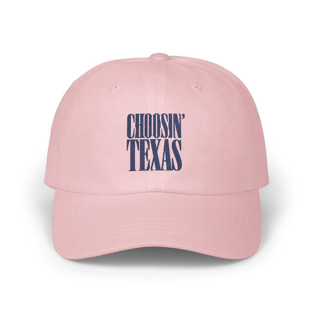 A pink baseball cap featuring embroidered navy blue text that reads CHOOSIN TEXAS on the front.