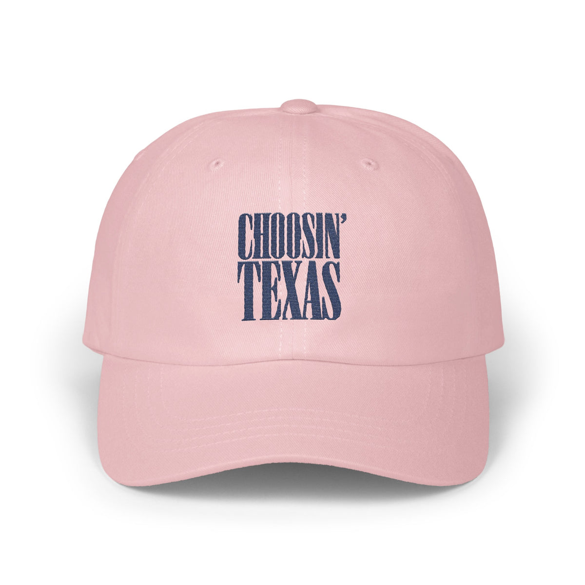 A pink baseball cap featuring embroidered navy blue text that reads CHOOSIN TEXAS on the front.