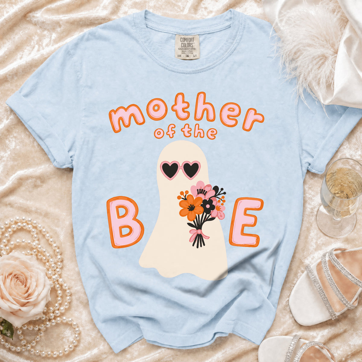 Light blue t-shirt with "Mother of the Bride" text, ghost graphic, and flowers.