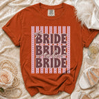 Orange t-shirt with "Bride to be Bride" text and a bow graphic.