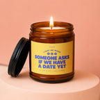 Brown glass candle with lit flame and "Vowed" label text about dating.