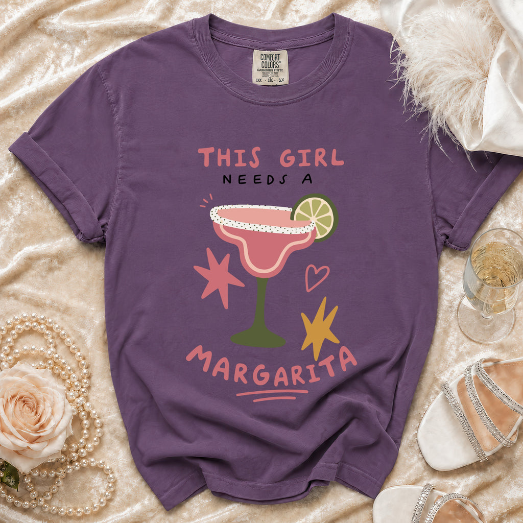 Purple t-shirt with "THIS GIRL NEEDS A MARGARITA" and margarita graphic.