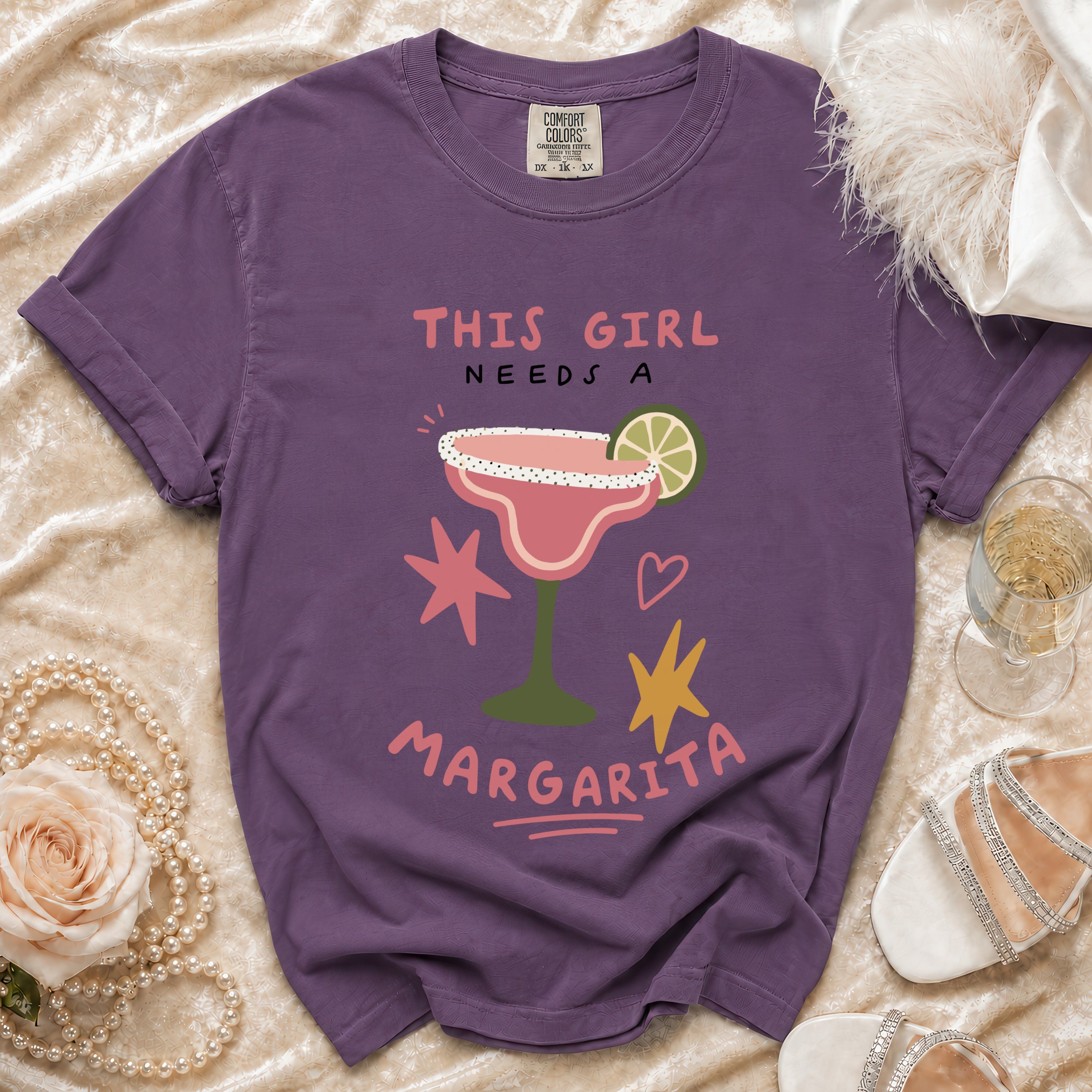 Purple t-shirt with "THIS GIRL NEEDS A MARGARITA" and margarita graphic.