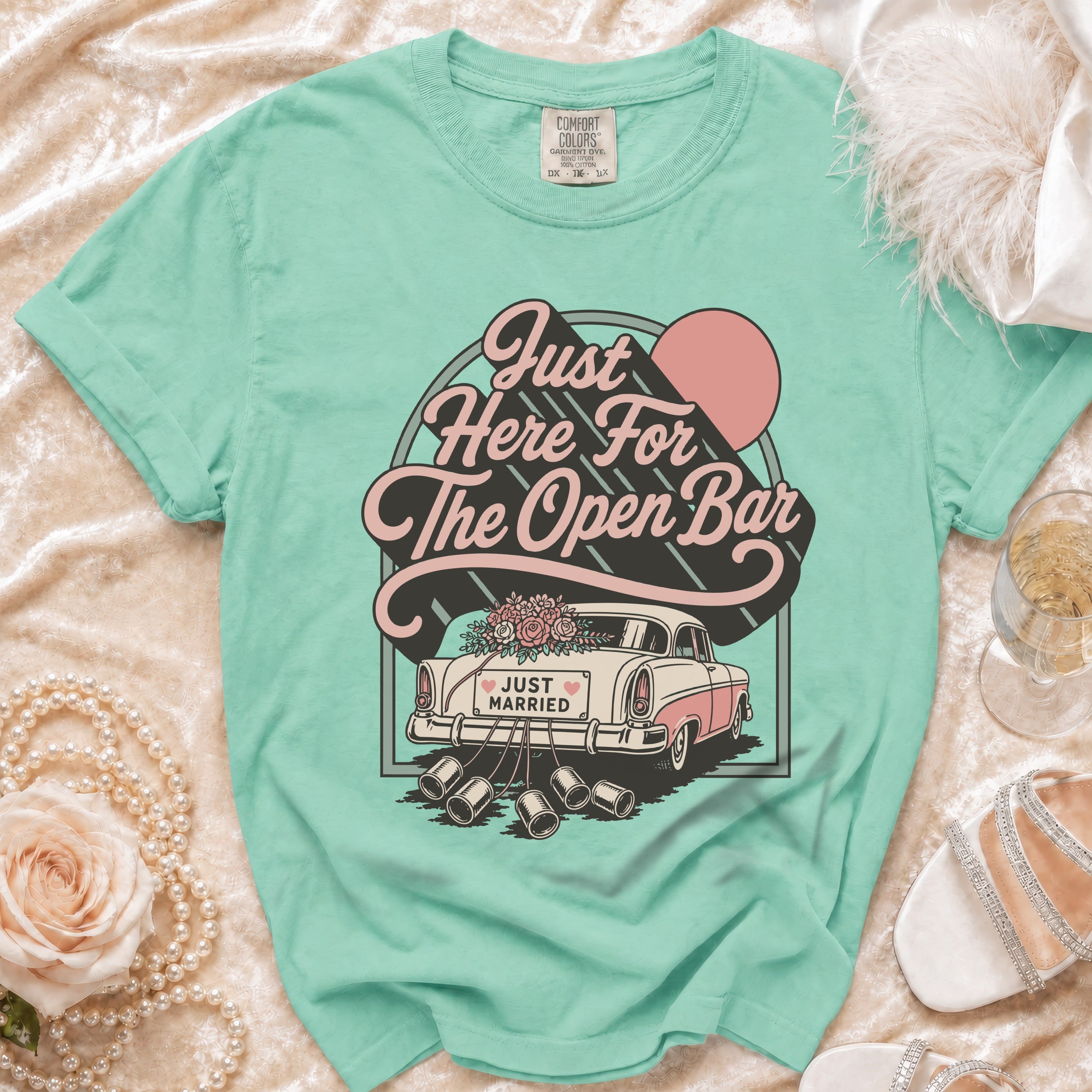 Mint green t-shirt with "Just Here For The Open Bar" graphic and a vintage car.