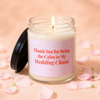 Glass candle with lit wick, pink label reading "Thank You for Being the Calm in My Wedding Chaos."