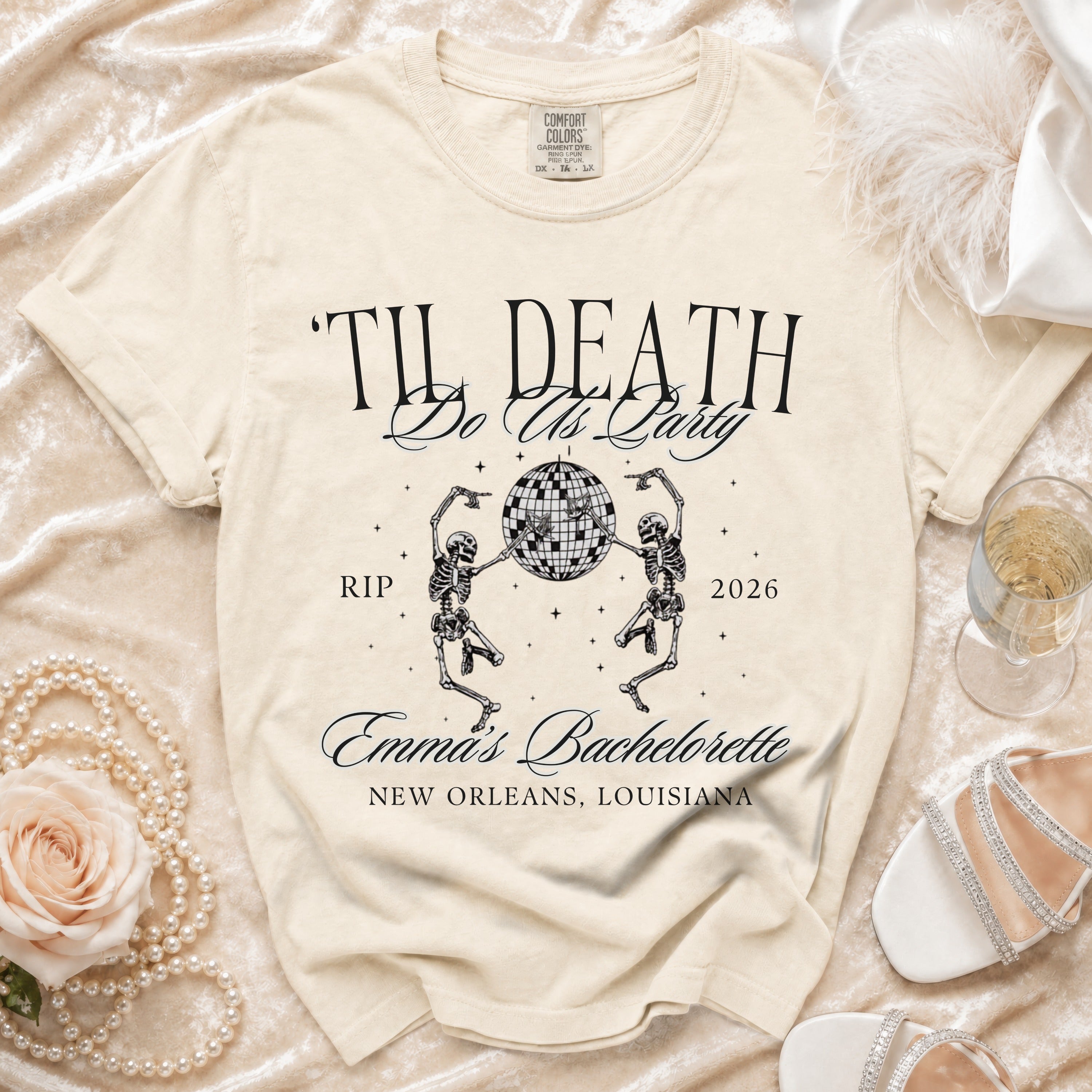 Cream t-shirt with "Til Death Do Us Party" text, skeletons, and party details.