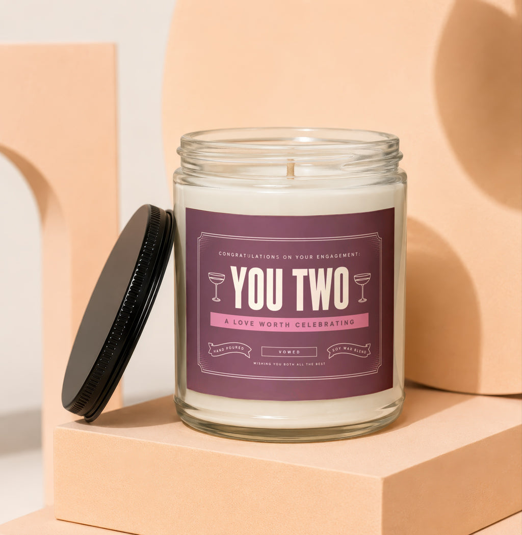 Candle with "You Two" label for engagement celebration, hand-poured soy wax blend.