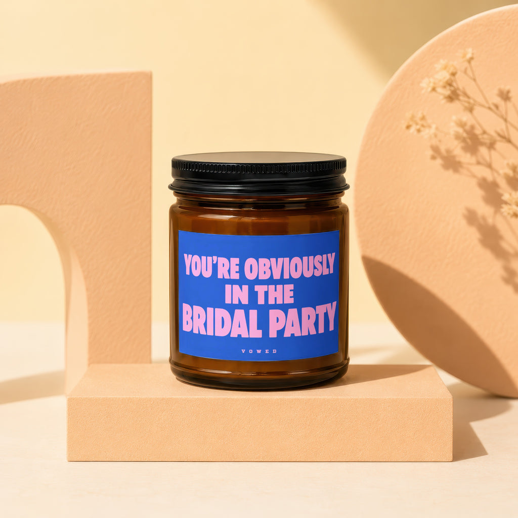 Brown candle with blue label reading "YOU'RE OBVIOUSLY IN THE BRIDAL PARTY"