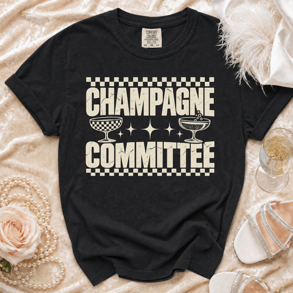 Black t-shirt with "CHAMPAGNE COMMITTEE" text and champagne glasses graphic.