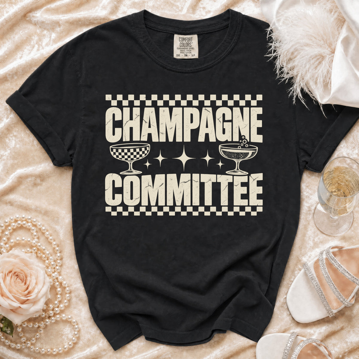 Black t-shirt with "CHAMPAGNE COMMITTEE" text and champagne glasses graphic.