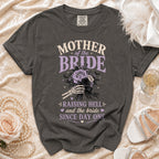 Dark grey t-shirt with "Mother of the Bride Raising Hell" graphic.
