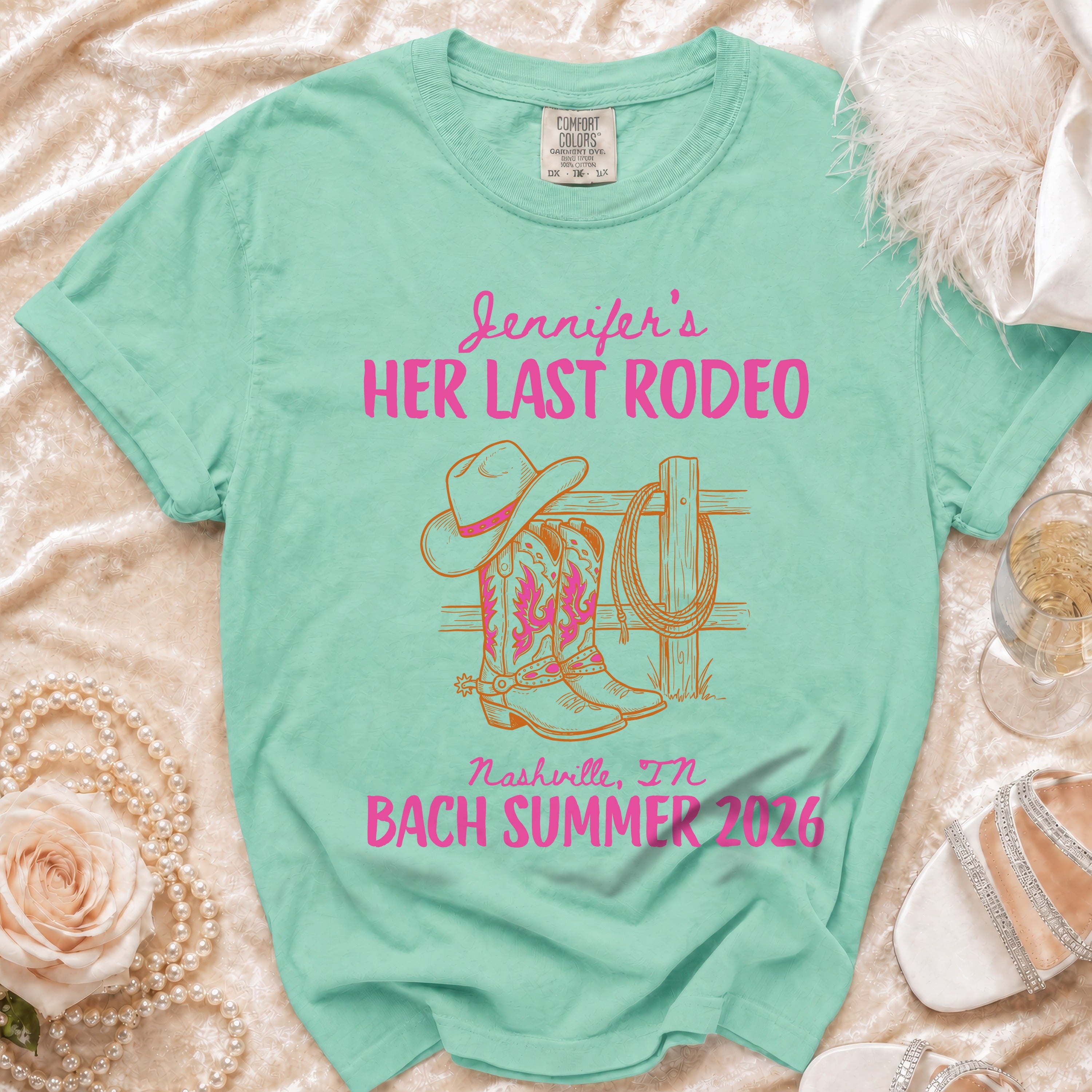 Teal t-shirt with "Jennifer's Her Last Rodeo Nashville, TN Bach Summer 2026" and cowboy graphic.