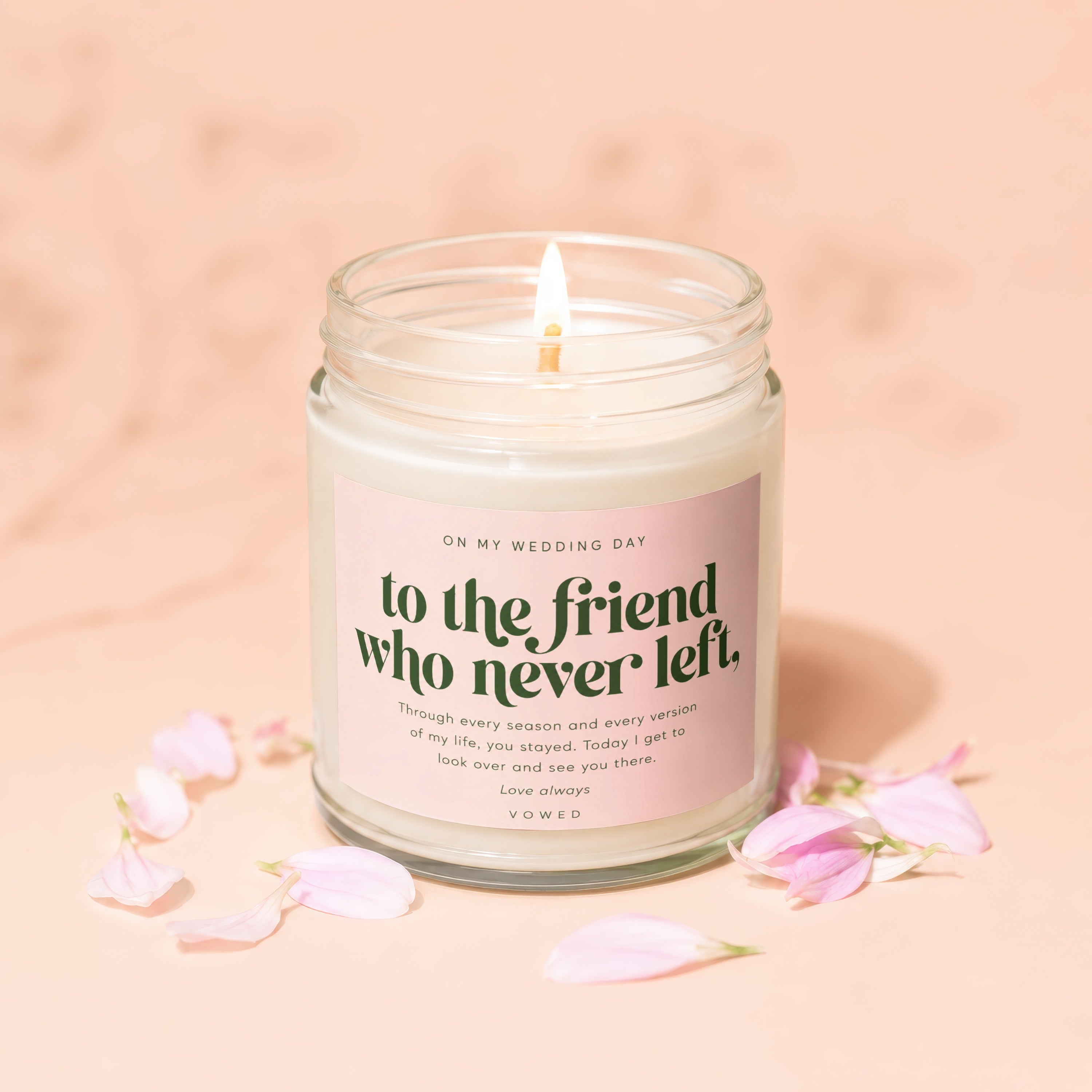 Candle with text "To the friend who never left" on pink label.