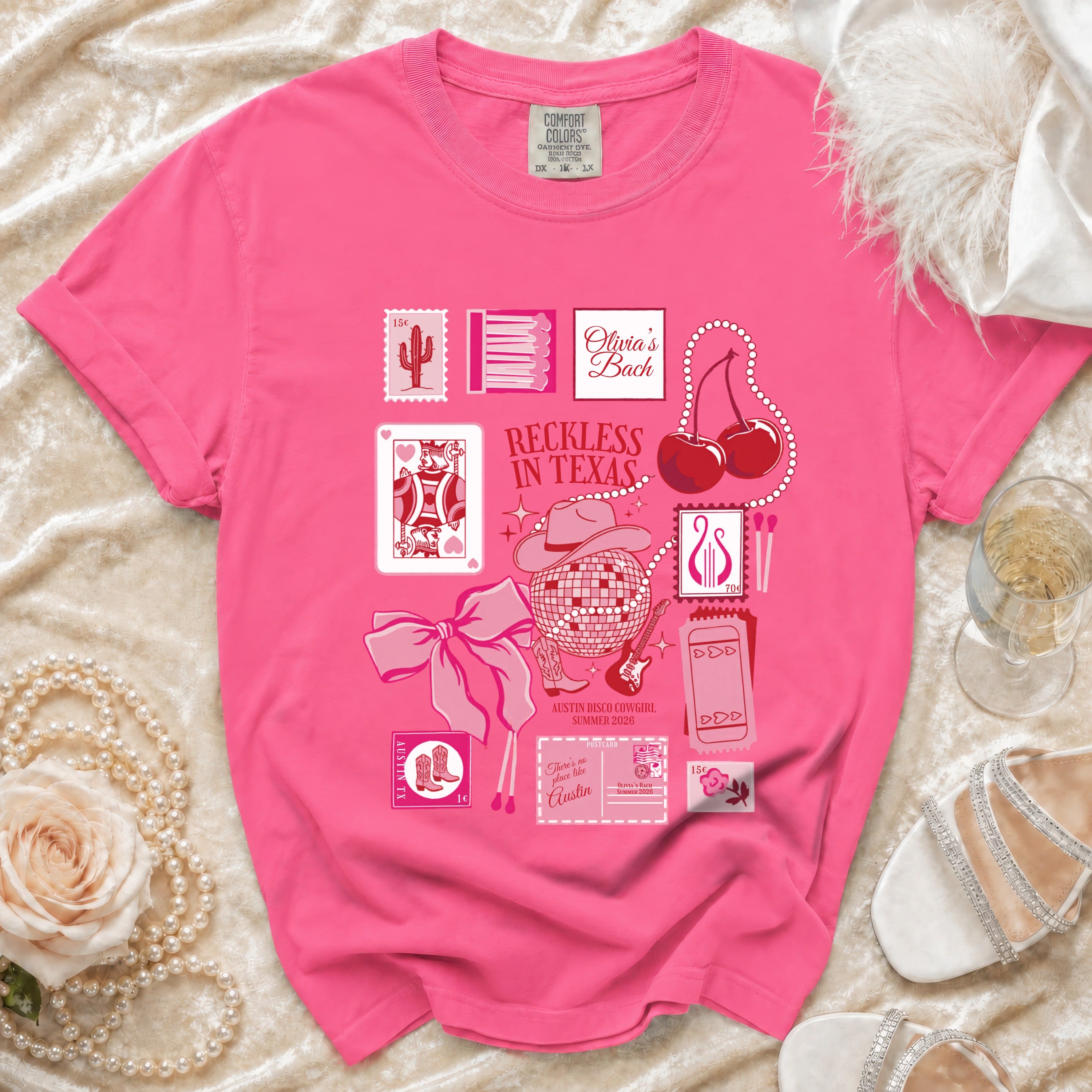 Pink graphic tee with "Reckless in Texas Austin Disco Cowgirl" text and country motifs.