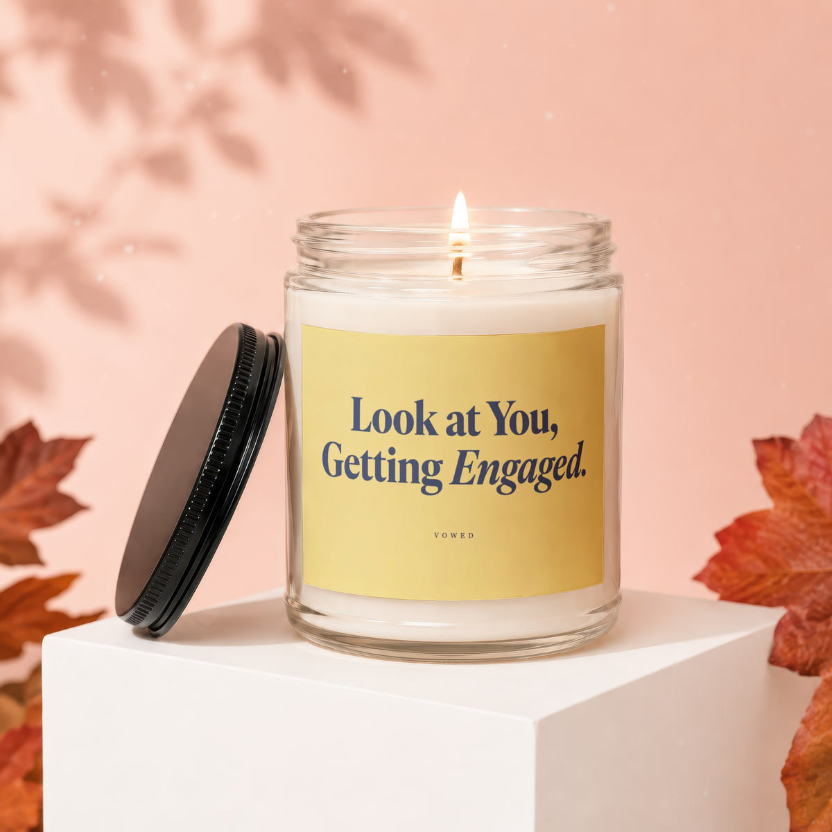Glass candle with label reading "Look at You, Getting Engaged. VOWED".