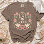 Brown t-shirt with "Love in Bloom" floral design and wedding rings.