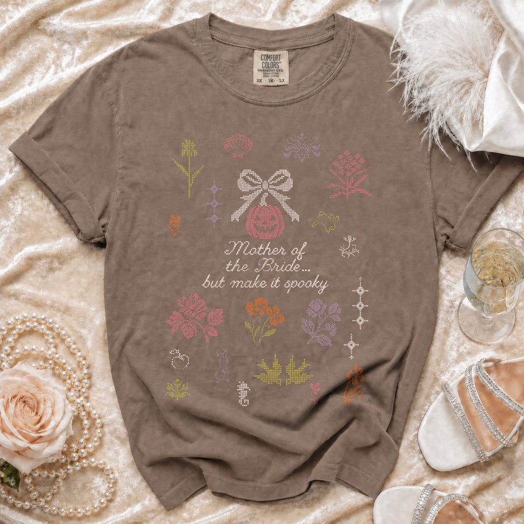 Brown t-shirt with "Mother of the Bride... but make it spooky" text and cross-stitch designs.
