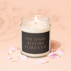 Candle with "The Spark Before Forever" text and pink petals.
