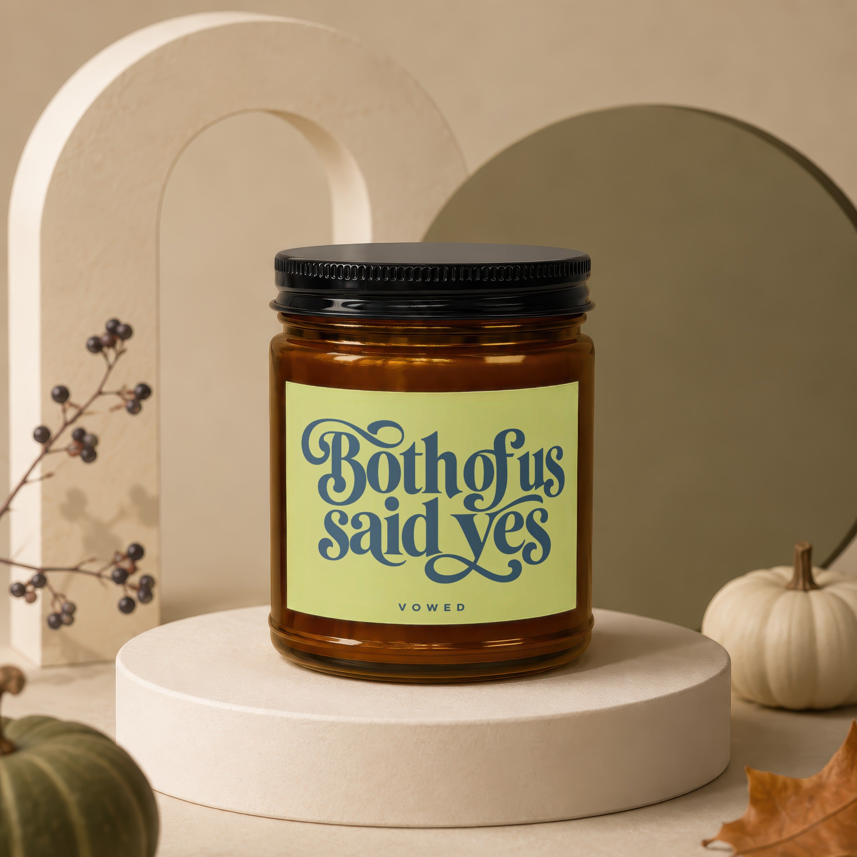 Amber glass candle with black lid, inscribed "Both of us said yes" and "vowed".