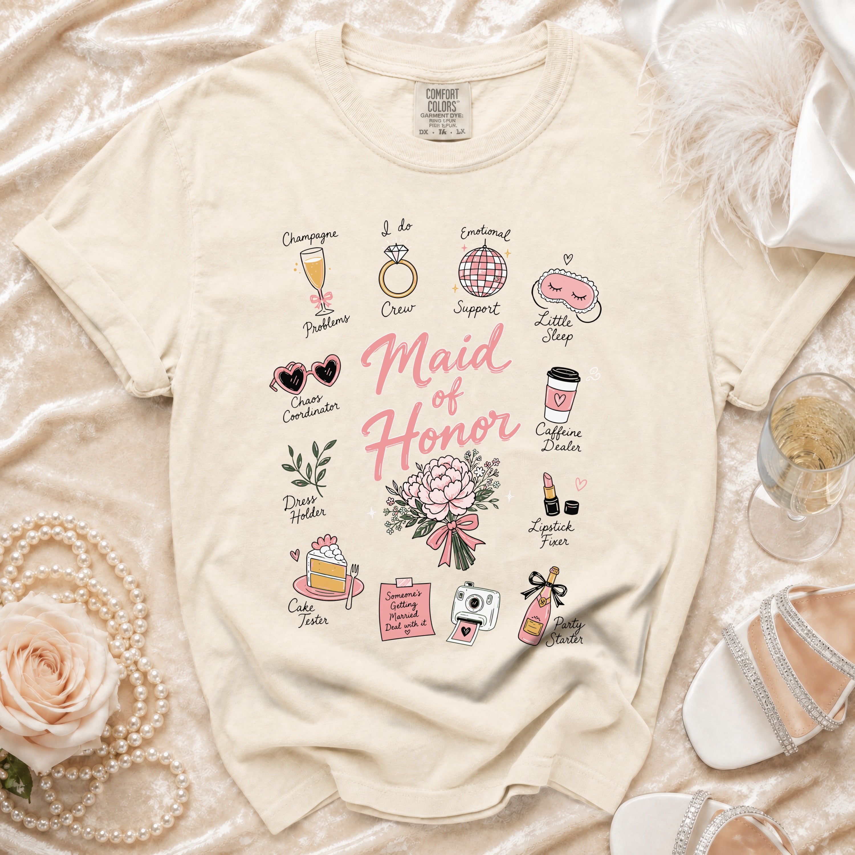 Cream t-shirt with "Maid of Honor" text and wedding-themed icons.