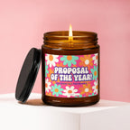 Amber jar candle with floral label reading "Proposal of the Year!" and "Vowed".