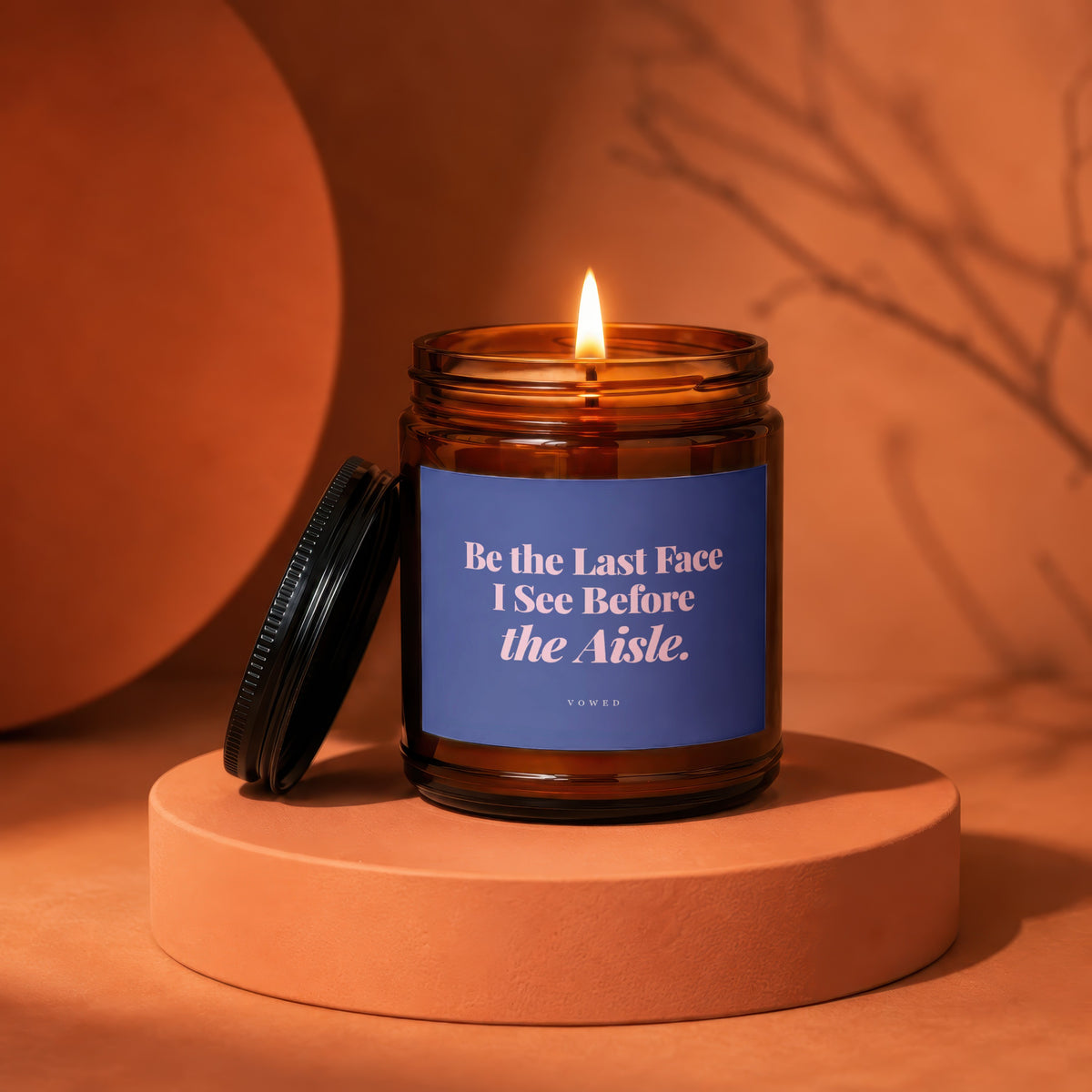 Amber jar candle with blue label reading "Be the Last Face I See Before the Aisle. VOWED."