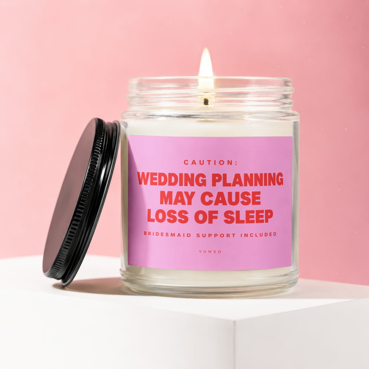 Candle with pink label reading "Caution: Wedding Planning May Cause Loss of Sleep"