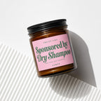 Brown jar with pink label that reads "Smells Like Sponsored by Dry Shampoo"