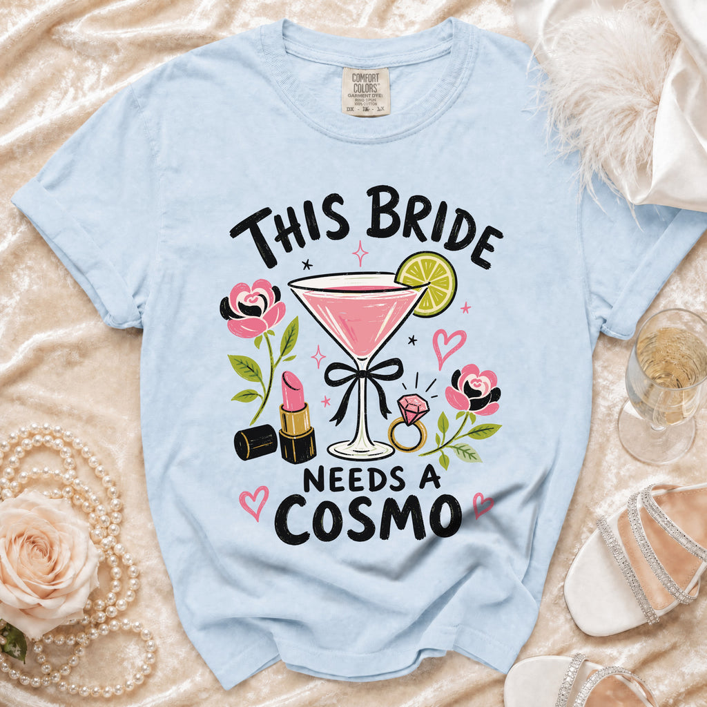 Light blue t-shirt with "This Bride Needs a Cosmo" design including a martini.
