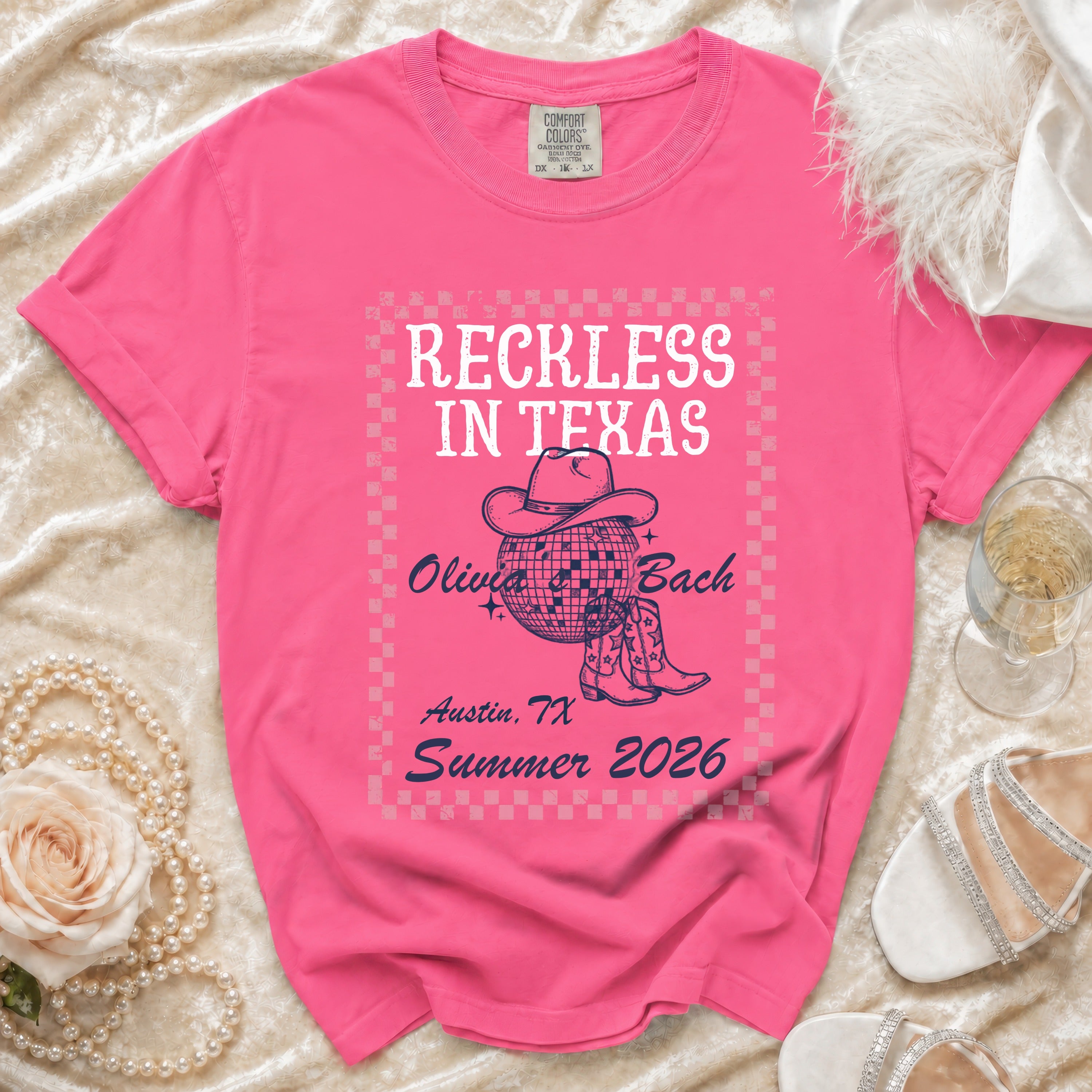 Pink t-shirt with "Reckless in Texas" graphic, Olivia Bach, Austin, TX, Summer 2026.