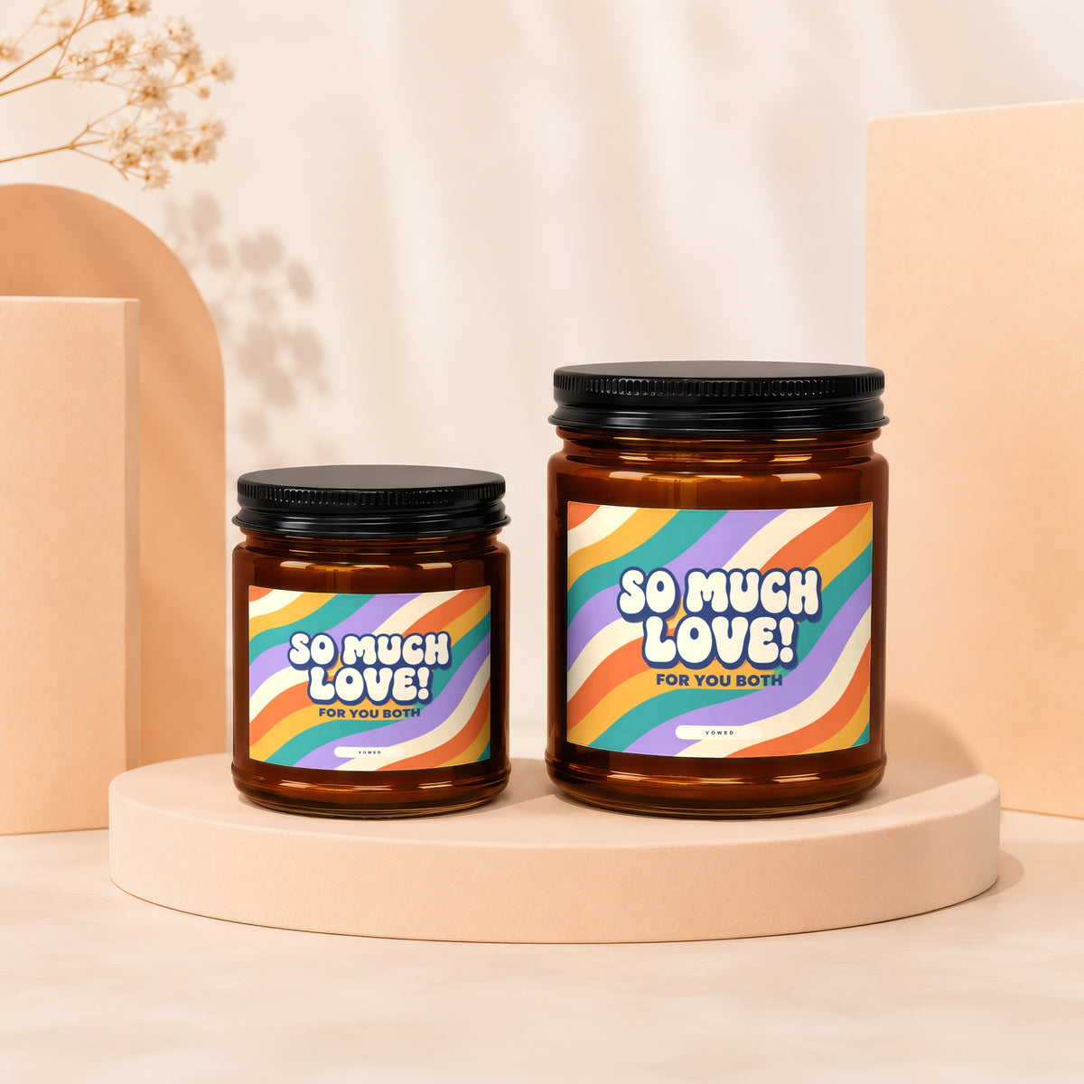 Two amber glass candles with black lids, each labeled "So Much Love! For You Both".