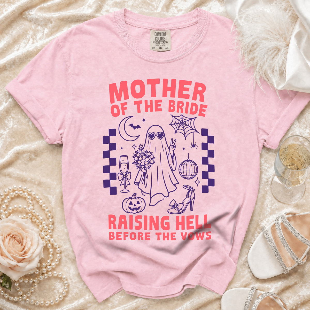 Pink t-shirt with "MOTHER OF THE BRIDE RAISING HELL BEFORE THE VOWS" graphic.