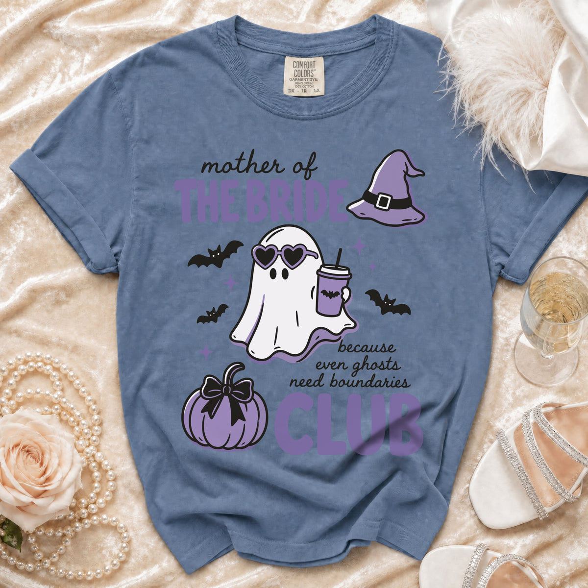 Blue t-shirt with "Mother of the Bride Club" text, ghost, bats, pumpkin, and witch hat graphic.